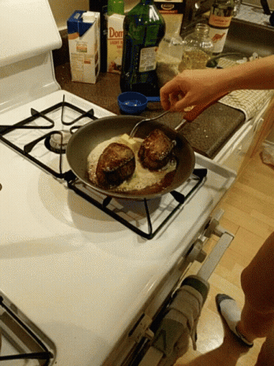 A Person Is Cooking On A Stove Next To A Box Of Don 'S GIF