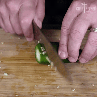 A Person Is Cutting A Jalapeno Pepper On A Wooden Cutting Board With Chili Pepper Written On The Bottom GIF