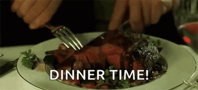 A Person Is Cutting A Piece Of Steak With A Fork And Knife On A Plate . GIF