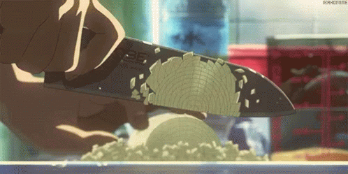 A Person Is Cutting A Vegetable With A Knife In A Kitchen . GIF