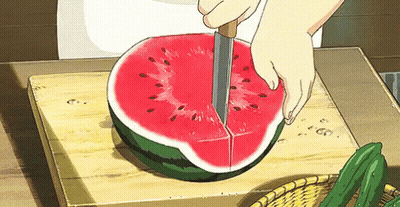 A Person Is Cutting A Watermelon On A Cutting Board . GIF