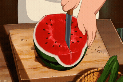 A Person Is Cutting A Watermelon On A Cutting Board With A Knife GIF