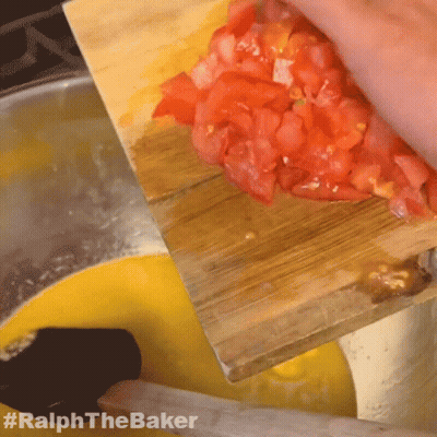 A Person Is Cutting Up Tomatoes On A Wooden Cutting Board With #Ralphthebaker Written On The Bottom GIF