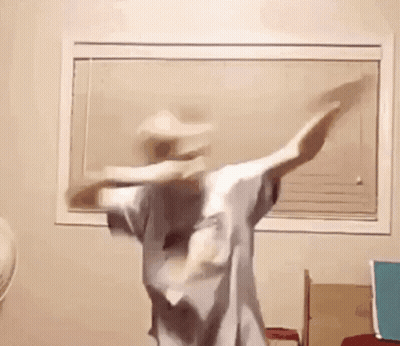 A Person Is Dancing In A Room In Front Of A Window . GIF