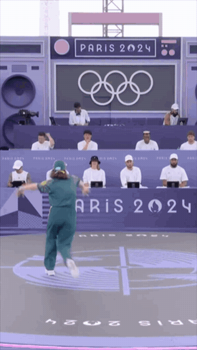 A Person Is Dancing In Front Of A Sign That Says Aris 2024 GIF