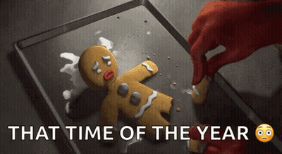 A Person Is Decorating A Gingerbread Man With Icing On A Pan . GIF