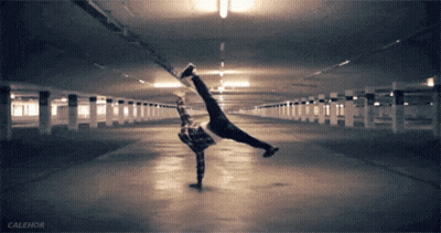 A Person Is Doing A Handstand In A Parking Garage With Calehor Written On The Bottom GIF