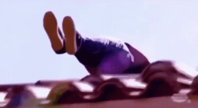 A Person Is Doing A Handstand On A Roof With Their Feet Up In The Air . GIF