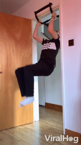 A Person Is Doing A Pull Up On A Door With Viralhog Written On The Bottom Right GIF