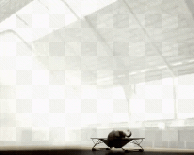 A Person Is Doing A Trick On A Table In Front Of A Window . GIF