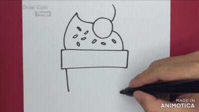 A Person Is Drawing A Cake On A Piece Of Paper With The Words Draw Cute Things Above It GIF