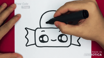 A Person Is Drawing A Candy Bar With A Black Marker On A Piece Of Paper GIF