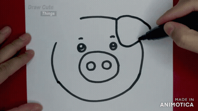 A Person Is Drawing A Pig On A Piece Of Paper With A Marker GIF