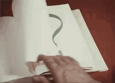 A Person Is Drawing A Question Mark On A Piece Of Paper With A Pen . GIF
