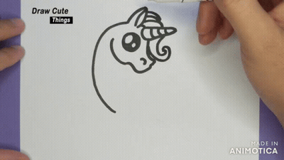 A Person Is Drawing A Unicorn On A Piece Of Paper With A Marker GIF