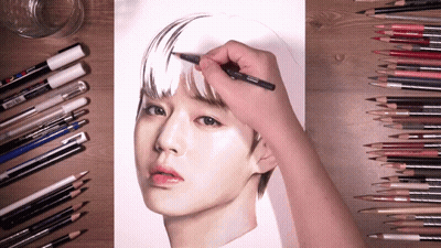 A Person Is Drawing A Woman 'S Face With Colored Pencils And Markers GIF