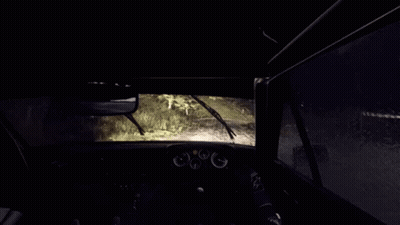A Person Is Driving A Car In The Rain With A Fence In The Background . GIF