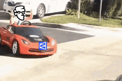 A Person Is Driving A Red Toy Car On The Street GIF
