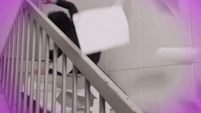 A Person Is Falling Down A Set Of Stairs While Holding A Piece Of Paper GIF