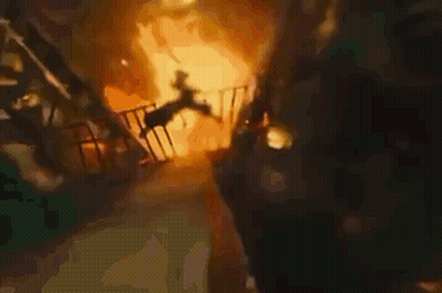 A Person Is Falling From A Balcony Into A Fire . GIF