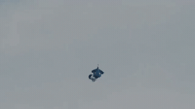 A Person Is Falling From A Parachute That Says Red Bull GIF
