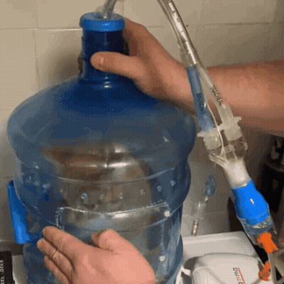 A Person Is Filling A Bottle Of Water With A Syringe That Says ' Boiling ' GIF