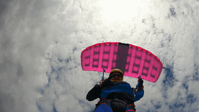 A Person Is Flying Through The Air With A Pink Parachute That Says " Beef " On It GIF