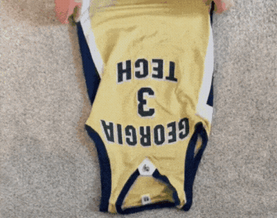 A Person Is Folding A Jersey With The Number 3 On It GIF