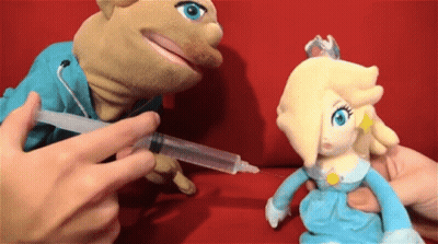 A Person Is Giving A Stuffed Animal A Syringe GIF