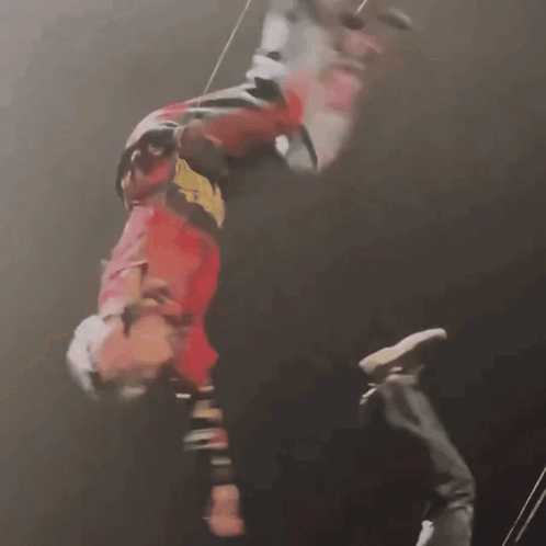 A Person Is Hanging Upside Down In The Air GIF