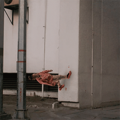 A Person Is Hanging Upside Down Near A Pole That Has Bns1 Written On It GIF