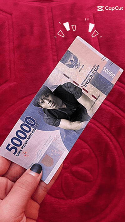 A Person Is Holding A 50000 Indonesian Bill GIF