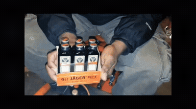A Person Is Holding A 9Er Jager Pack Of Liquor GIF