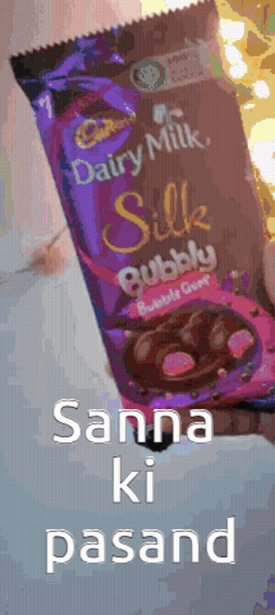 A Person Is Holding A Bag Of Cadbury Silk Bubble Candy GIF