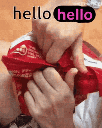 A Person Is Holding A Bag Of Chips And Says Hello GIF