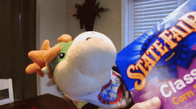 A Person Is Holding A Bag Of State Fair Class Corn GIF