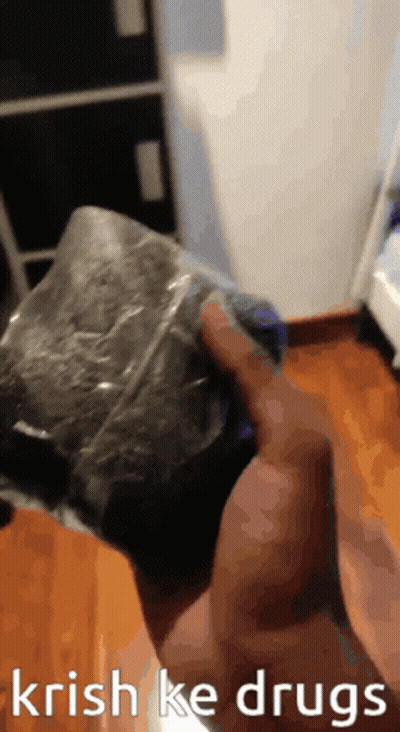A Person Is Holding A Bag That Says ' Krish Ke Drugs ' On The Bottom GIF