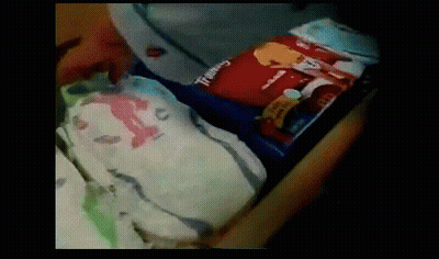 A Person Is Holding A Bag That Says Tommy GIF