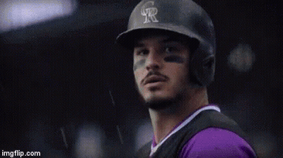A Person Is Holding A Baseball Glove With The Name Nolan On It GIF