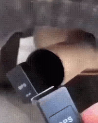 A Person Is Holding A Black Gps Device In Their Hand GIF