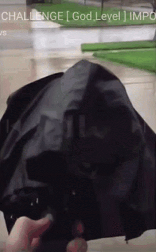 A Person Is Holding A Black Umbrella With The Words Challenge God Level Impo On The Bottom GIF