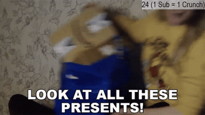 A Person Is Holding A Blue Box With The Words Look At All These Presents Written On It GIF