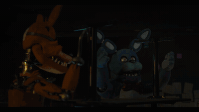 A Person Is Holding A Blue Object In Their Hand In A Dark Room GIF
