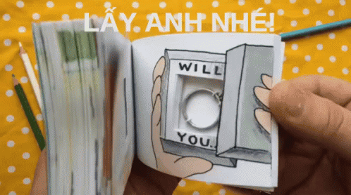 A Person Is Holding A Book That Says Will You GIF