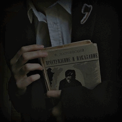 A Person Is Holding A Book With A Picture Of A Shield On It GIF