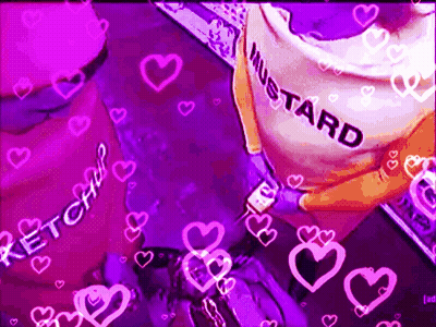 A Person Is Holding A Bottle Of Mustard In Front Of A Purple Background With Pink Hearts . GIF