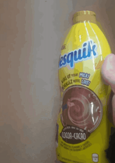 A Person Is Holding A Bottle Of Nesquik Cocoa Cacao GIF