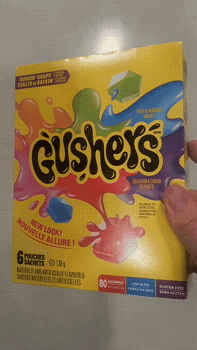 A Person Is Holding A Box Of Cushey 'S In Their Hand GIF