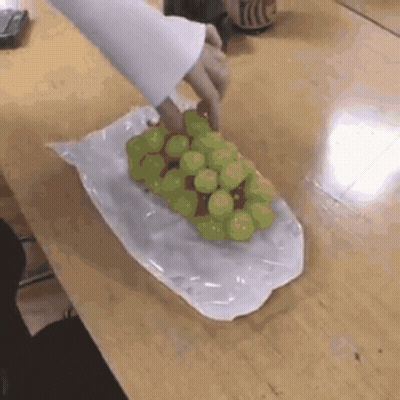A Person Is Holding A Bunch Of Grapes In A Plastic Bag GIF