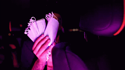 A Person Is Holding A Bunch Of Money In Their Hand GIF